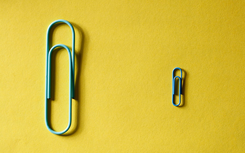 Two paper clips of the small and large size.